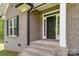 Close up of front entry featuring a black door and steps with brick detail on the side of the home at 2489 Highway 161 S Hwy, York, SC 29745