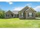 Well-maintained home with a green lawn and a front entrance showing black door and covered porch at 2489 Highway 161 S Hwy, York, SC 29745