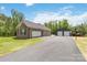 A detached two-car garage and a barn with an outdoor basketball court in a backyard at 2489 Highway 161 S Hwy, York, SC 29745