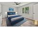 This bedroom features a ceiling fan, large windows, and staged furniture and decor at 2544 Cedarwild Rd, Charlotte, NC 28212
