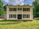 Inviting home featuring a symmetrical facade, black shutters, a well-maintained lawn, and a classic colonial design at 2544 Cedarwild Rd, Charlotte, NC 28212