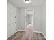 Well-lit hallway with modern flooring, gray walls, white trim, and access to a spacious living area at 2544 Cedarwild Rd, Charlotte, NC 28212