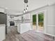Bright kitchen featuring stainless appliances, a center island, and sliding door access to an outdoor deck and seating at 2544 Cedarwild Rd, Charlotte, NC 28212