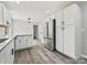 Spacious kitchen featuring stainless steel appliances, modern white cabinetry, granite counters, and stylish flooring at 2544 Cedarwild Rd, Charlotte, NC 28212