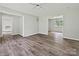 Expansive living room with a seamless flow, updated flooring, and access to other rooms at 2544 Cedarwild Rd, Charlotte, NC 28212