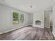 Bright living room with hardwood floors, fireplace, and a large window providing ample natural light at 2544 Cedarwild Rd, Charlotte, NC 28212