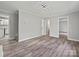 Spacious living room featuring modern gray walls, stylish floors, and a contemporary light fixture at 2544 Cedarwild Rd, Charlotte, NC 28212