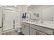 This bathroom features double sinks, a white vanity, and a tile shower at 2939 Penninger Cir, Charlotte, NC 28262