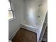 Bathroom highlighting a clean white tub and shower with tiled flooring, complemented by natural light at 3048 Marigold Ln, Gastonia, NC 28052