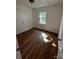 Bedroom showcasing gleaming hardwood floors and a window, enhanced by a neutral color palette for a serene feel at 3048 Marigold Ln, Gastonia, NC 28052
