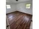 Bedroom featuring polished hardwood floors, dual windows for ample sunlight, and crisp, white walls at 3048 Marigold Ln, Gastonia, NC 28052