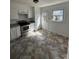 Bright kitchen with white cabinets, stainless steel appliances, and tile flooring at 3048 Marigold Ln, Gastonia, NC 28052