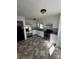 Bright kitchen with white cabinets, stainless steel appliances, and tile flooring at 3048 Marigold Ln, Gastonia, NC 28052