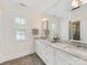 Bathroom featuring double sinks, marble countertops, and a large mirror with good natural light at 3101 Auburn Ave, Charlotte, NC 28209