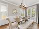 Bright dining room featuring a farmhouse table set, modern chandelier, and natural light at 3101 Auburn Ave, Charlotte, NC 28209