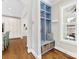 Entryway with a built-in blue storage bench, coat hooks, and an adjacent view into the kitchen at 3101 Auburn Ave, Charlotte, NC 28209