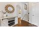 Welcoming entryway boasts hardwood floors, stylish console table and decor, leading to stairs at 3101 Auburn Ave, Charlotte, NC 28209