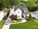 Aerial view of a beautifully landscaped home with a white exterior and manicured lawn at 3101 Auburn Ave, Charlotte, NC 28209