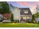 Charming home with manicured lawn, lush landscaping, and a welcoming front porch at sunset at 3101 Auburn Ave, Charlotte, NC 28209