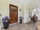 Inviting front porch featuring a wood door, slate flooring, and decorative plants and seating at 3101 Auburn Ave, Charlotte, NC 28209