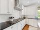 Clean white kitchen with stainless steel hood and appliances plus dark granite countertops and light subway tiles at 3101 Auburn Ave, Charlotte, NC 28209