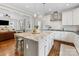 White kitchen with granite island, stainless steel appliances, and seamless transition to other living spaces at 3101 Auburn Ave, Charlotte, NC 28209