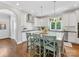 Bright kitchen with granite counters, subway tile backsplash, and an island with barstool seating for three at 3101 Auburn Ave, Charlotte, NC 28209