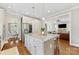 Open concept kitchen with granite island, stainless steel fridge, and a view into the living and dining areas at 3101 Auburn Ave, Charlotte, NC 28209
