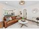Comfortable living room with leather couch, open to the kitchen, with a round coffee table and stylish decor at 3101 Auburn Ave, Charlotte, NC 28209