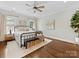Spacious main bedroom with a ceiling fan, hardwood floors, a rug, and two windows letting in natural light at 3101 Auburn Ave, Charlotte, NC 28209
