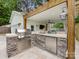 Outdoor kitchen featuring stone counter, stainless steel grill, and cabinetry at 3101 Auburn Ave, Charlotte, NC 28209