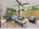 Beautiful covered patio with stone fireplace, ceiling fan, and comfortable seating area at 3101 Auburn Ave, Charlotte, NC 28209