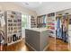 Spacious walk-in closet with custom shelving, storage island, and hardwood floors at 3101 Auburn Ave, Charlotte, NC 28209