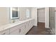 Bathroom featuring dual sinks, illuminated mirrors, and walk-in closet at 3630 N Davidson St # 3301, Charlotte, NC 28205