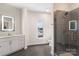 Elegant bathroom featuring a tiled walk-in shower, quartz countertop, and backlit mirror at 3630 N Davidson St # 3301, Charlotte, NC 28205