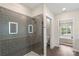 Modern bathroom featuring glass enclosed shower and a view to bedroom at 3630 N Davidson St # 3301, Charlotte, NC 28205