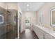Sleek bathroom featuring glass-enclosed shower and dual vanities with a view to bedroom at 3630 N Davidson St # 3301, Charlotte, NC 28205