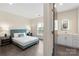 Bright bedroom featuring a queen-sized bed, stylish nightstands, and a full ensuite bathroom at 3630 N Davidson St # 3301, Charlotte, NC 28205