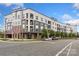 Modern apartment building exterior featuring balconies, stylish gray and white siding, and well-maintained landscaping at 3630 N Davidson St # 3301, Charlotte, NC 28205