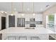 Well-equipped kitchen featuring white cabinets, stainless steel appliances, and a large center island at 3630 N Davidson St # 3301, Charlotte, NC 28205