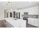 Modern kitchen with stainless steel appliances, a large island, and gray backsplash at 3630 N Davidson St # 3301, Charlotte, NC 28205