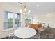 Bright living room featuring large windows, dining table and a modern chandelier at 3630 N Davidson St # 3301, Charlotte, NC 28205