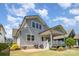 Stunning backyard featuring a covered porch, manicured lawn, and elegant patio area, perfect for outdoor entertaining at 376 Sensibility Cir # 8, Fort Mill, SC 29708
