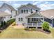 Aerial view of the backyard featuring a covered porch, well-maintained lawn, and a charming patio at 376 Sensibility Cir # 8, Fort Mill, SC 29708