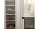 Bright bathroom with decorative built-in linen closet featuring stylish storage and a gray vanity at 376 Sensibility Cir # 8, Fort Mill, SC 29708