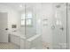 Bright, modern bathroom with a glass shower, built-in tub and stylish black and white tiled floors at 376 Sensibility Cir # 8, Fort Mill, SC 29708