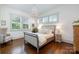 Serene bedroom with a chandelier, large windows, and a comfortable bed in a bright and airy space at 376 Sensibility Cir # 8, Fort Mill, SC 29708