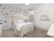 Serene bedroom featuring a floral wallpaper accent wall, a queen-size bed, and natural light at 376 Sensibility Cir # 8, Fort Mill, SC 29708