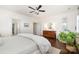 Bright bedroom with a ceiling fan, hardwood floors, a plant, and a dresser at 376 Sensibility Cir # 8, Fort Mill, SC 29708