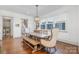 Bright dining room with hardwood floors, a wooden table, bench seating, and a staircase at 376 Sensibility Cir # 8, Fort Mill, SC 29708